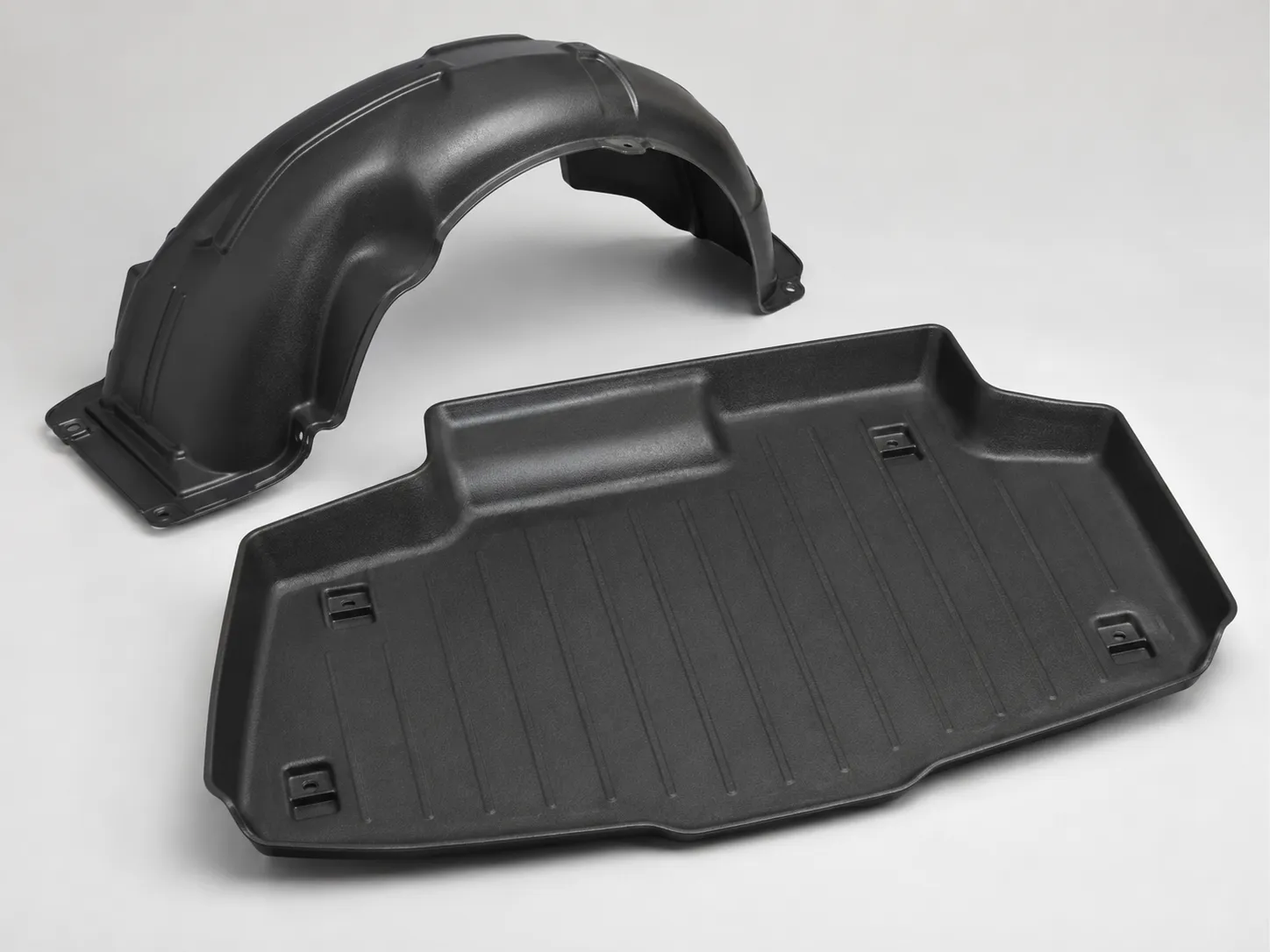Black thermoformed automotive wheel-arch liner and load-floor tray