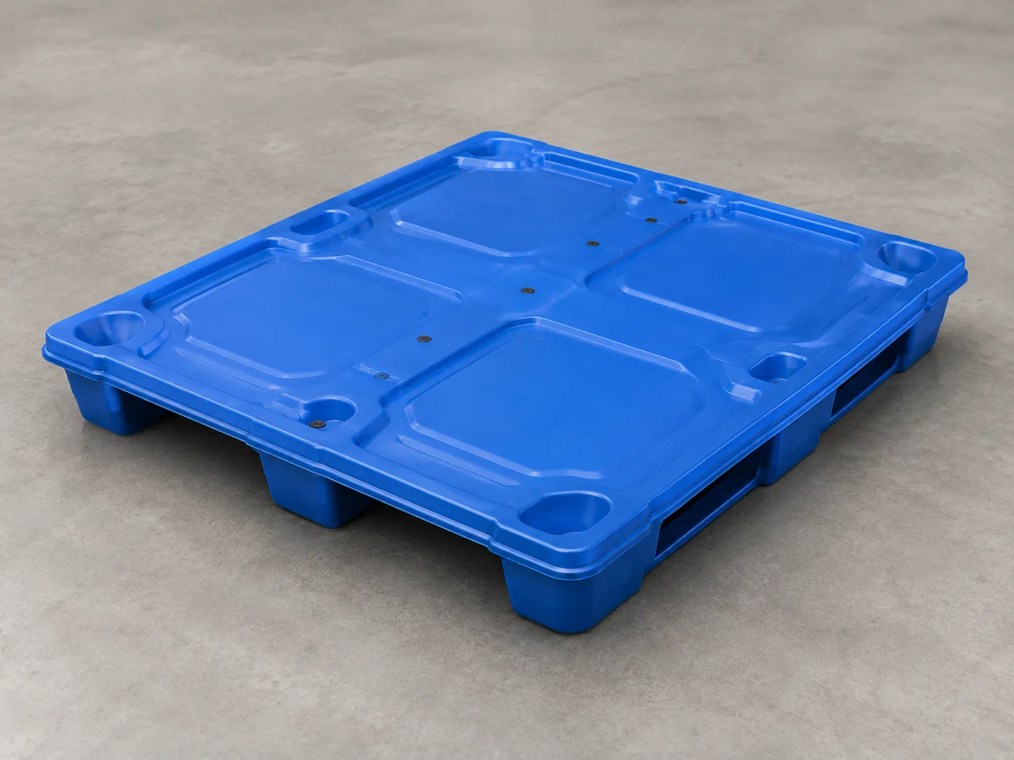 Blue thermoformed twin-sheet plastic pallet on a warehouse floor