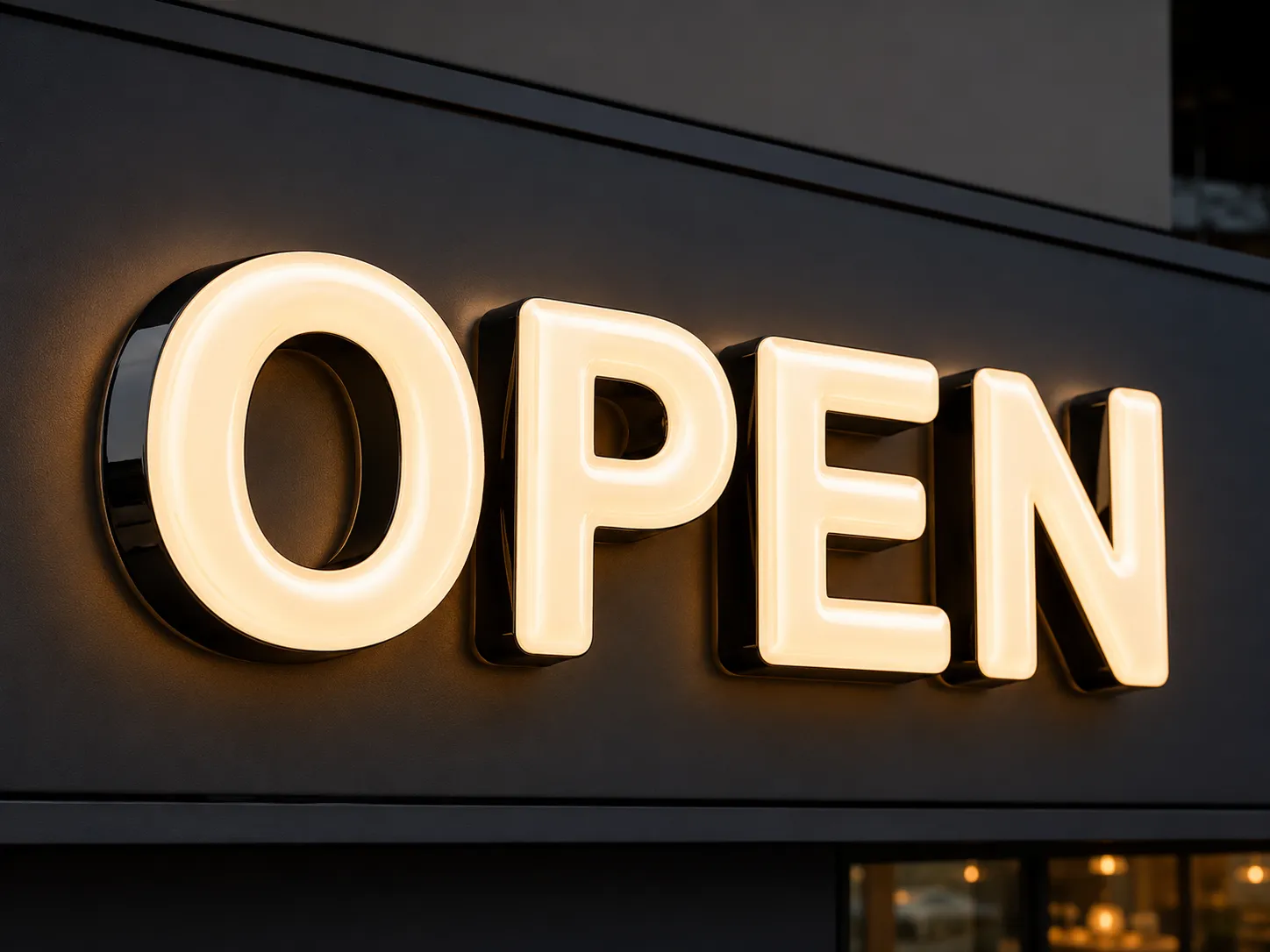 Illuminated 3D vacuum-formed channel letters spelling OPEN on a dark storefront